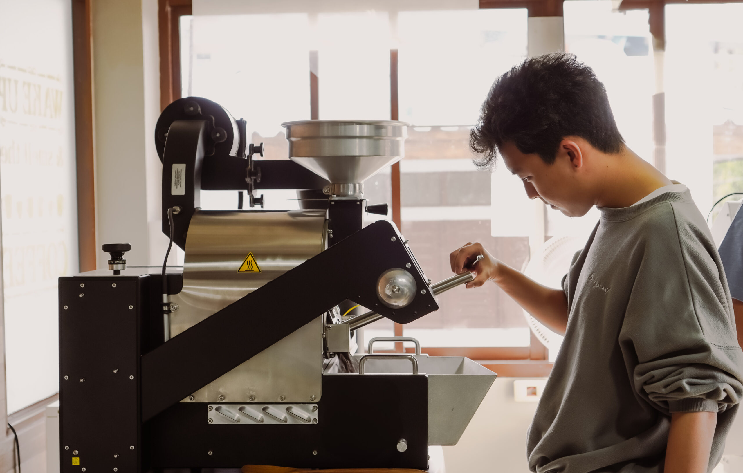 Coffee-Tech Engineering FZ94 Evo specialty coffee roaster operated by a roaster in a roastery